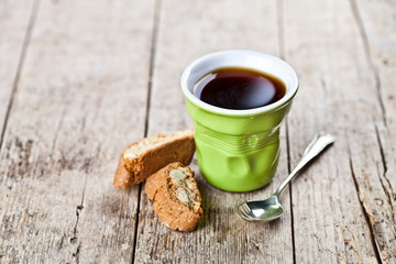 Wall Mural - Cup of coffee, fresh Italian cookies cantuccini with almond seeds on ructic wooden table background.