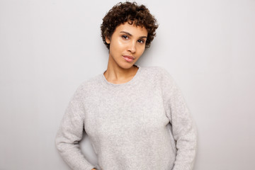 beautiful young woman posing by white wall