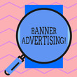 Text sign showing Banner Advertising. Business photo text advertisement that appears across the top of a web page Round magnifying glass with iron handle frame to make object look bigger