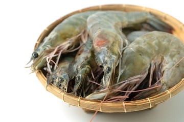 close up group of fresh raw pacific white shrimp in bamboo bowl on white background (Isolated background).