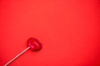 © liliyabatyrova - Red lollipop on coral background