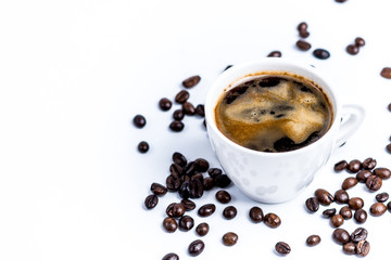 Cup with coffee beans on white background