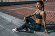 © byswat - Woman athlete resting after summer workout city. Headphones phone online application music social networks. Concept fitness fresh air active lifestyle workout. Tattoos tanned figure. Free space text.