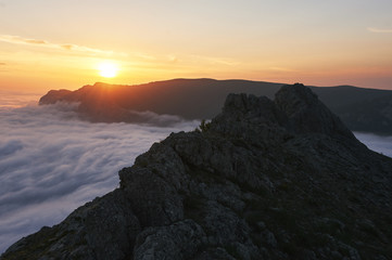 beautiful sunset above the clouds in the mountains. stunned landscape background with copy space. aerial mountain view