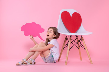 Cute little girl with speech icon on colored background