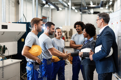 Happy African American manager greeting workers in a factory. - Buy this  stock photo and explore similar images at Adobe Stock | Adobe Stock