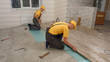 © DenisProduction.com - Men laying laminate flooring. Builders installing laminate floor. House repair concept.