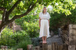 © Marc Romanelli - portrait of 13 year old girl wearing a long white dress outdoors