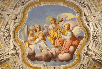 OSSUCCIO, ITALY - MAY 8, 2015: The baroque fresco choir of angels with the music instruments in church Sacro Monte della Beata Vergine del Soccorso by Salvatore Pozzi di Puria  (1595 – 1681).