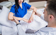 © romaset - Traumatologist examining patient hands in modern hospital