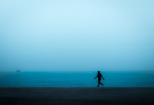 Person Jogging Alone At Blue Hour By Lake