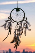 Dream Catcher With City View And Sunset On The Background