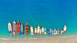 Boats in the sea, top view. Aerial view of colorful boats standing abreast on the shores of the Mediterranean sea in azure water. Nautical background and summer traveling concept.