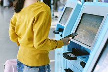 Traveler Using A Self Check-in Machine Kiosk Service At Airport, Technology And Smart Application To Confirm Flight Booking Details, Travel Concept.