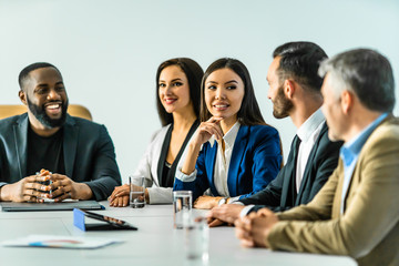 Wall Mural - The five business people sitting at the table