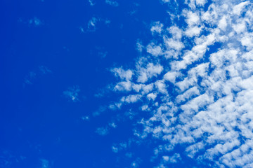 Blue sky background with white clouds.