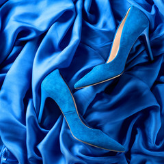 Wall Mural - Blue women's corduroy shoes on a silk background.