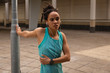 © Wavebreak Media - Woman listening music on earphones while exercising in the city