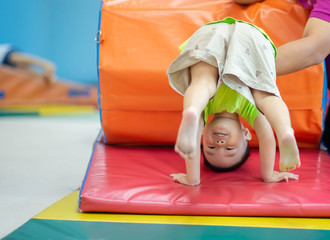 Little toddler boy working out at the indoor gym excercise