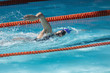 © Wavebreak Media - Female swimmer swimming freestyle in swimming pool