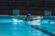© Wavebreak Media - Young female swimmer with swim goggle swimming at swimming pool