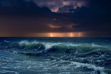 Huge Lightnings In Dark Stormy Sky Above Waving Sea