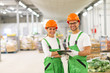 © bnenin - Portrait of a two happy quality control workers at food factory warehouse.