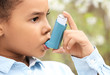 © Pixel-Shot - African-American girl with inhaler having asthma attack outdoors on spring day