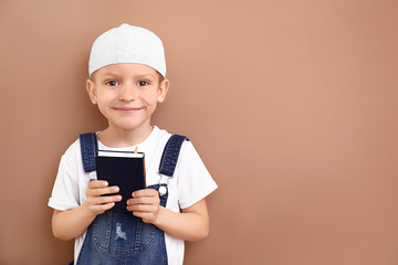 Wall Mural - Little Muslim boy with Koran on color background