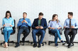 © Pixel-Shot - Young people waiting for job interview indoors