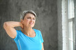 © Pixel-Shot - Mature woman suffering from neck pain at home