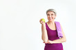 © Pixel-Shot - Sporty mature woman with towel and apple on white background