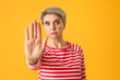 © Pixel-Shot - Portrait of mature woman showing STOP gesture on color background