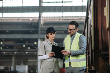 Manager talking to a female factory worker.