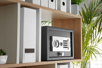modern safe on shelf in office