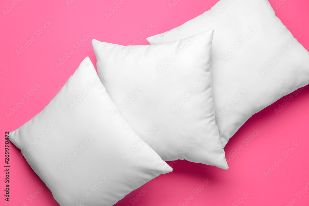 Soft pillows on color background