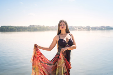 Attractive woman in a dress posing on the beach