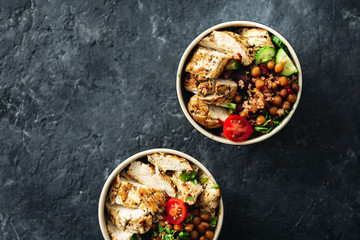 Wall Mural - Healthy food bowl buddha top view on dark background with copy space. Grilled chicken steak with spicy chickpeas, quinoa and baked beetroot