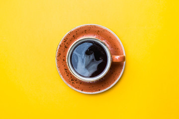 Wall Mural - Top view image of coffe cup on yellow background. Flat lay. Copy space