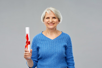 Poster - graduation, education and old people concept - happy senior graduate student woman with diploma over grey background