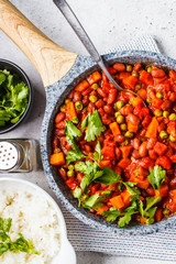 Wall Mural - Vegan bean stew with tomatoes and rice in a pan over white background.