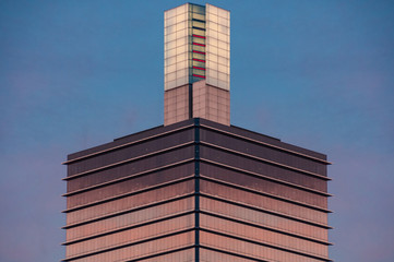 Architecture background of symmetrical skyscraper tower with glass wall