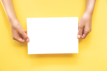 hands holding blank copy space letter on yellow background