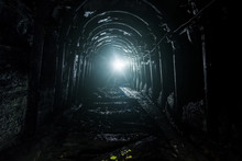 Dark Abandoned Coal Mine With Rusty Lining In Backlight