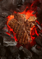 Wall Mural - grilled marbled beef steak with coals and smoke