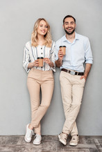 Full Length Photo Of European Couple In Casual Clothing Holding Paper Cups And Looking At Camera
