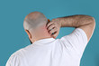© New Africa - Man with allergy symptoms scratching neck on color background