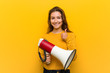 © Asier - Young european woman holding a megaphone smiling and raising thumb up