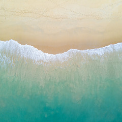 Wall Mural - Aerial view of turquoise ocean wave reaching the coastline. Beautiful tropical beach from top view. Andaman sea in Thailand. Summer holiday vacation concept