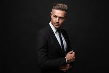 Portrait Of European Unshaved Businessman Dressed In Formal Suit Posing And Looking Aside